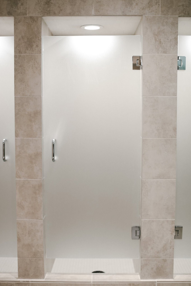 High end, fogged glass doors and tiled walls around showers.