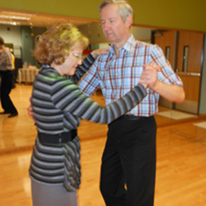 Senior couple dancing together during a senior fitness class.