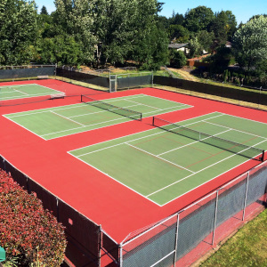 A stunning overhead view of all 3 of our red and green surfaced outdoor tennis courts.